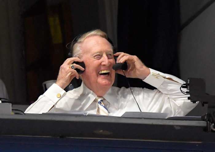 In this Monday, Sept. 19, 2016, file photo, Los Angeles Dodgers’ Hall of Fame announcer Vin Scully puts his headset on prior to a baseball game between the Los Angeles Dodgers and the San Francisco Giants in Los Angeles. Scully, whose dulcet tones provided the soundtrack of summer while entertaining and informing Dodgers fans in Brooklyn and Los Angeles for 67 years, died Tuesday night, Aug. 2, 2022, the team said. He was 94.